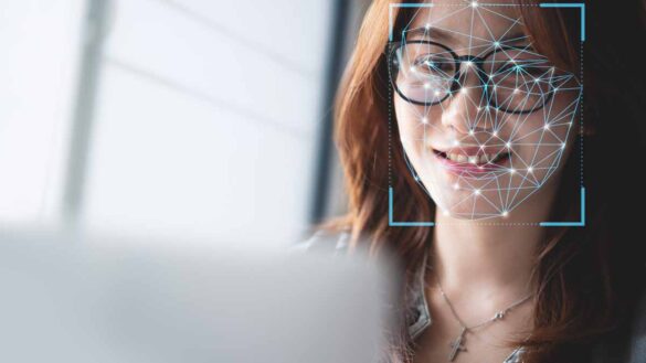 deepfakes HR employers. Photo shows a 3D matrix over young woman's face.